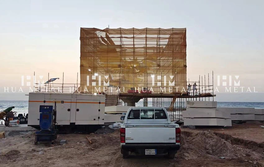 Preliminary site installation of brass falcon sculpture